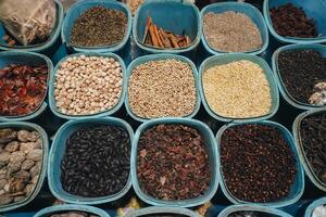 A closeup view of many types of herbs, placed on tray with square and rectangle shape. Traditional Indonesian medicine concept photo