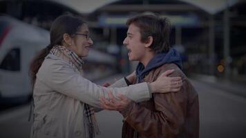 Reunion of Single Mother and Teenage Son Hugging at Railway Platform video