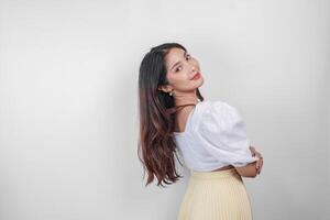 An attractive Asian woman is smiling to the camera, isolated by white background. photo