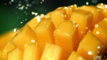 Raindrops fall on fresh mango. Filmed on a high-speed camera at 1000 fps. High quality FullHD footage video