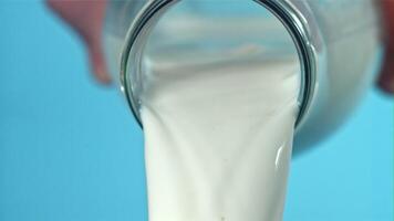 The milk is poured out of the bottle. Filmed on a high-speed camera at 1000 fps. High quality FullHD footage video