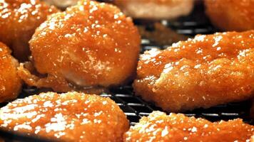 Chicken nuggets are fried in oil. Filmed on a high-speed camera at 1000 fps. High quality FullHD footage video