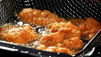 Chicken nuggets are fried in oil. Filmed on a high-speed camera at 1000 fps. High quality FullHD footage video