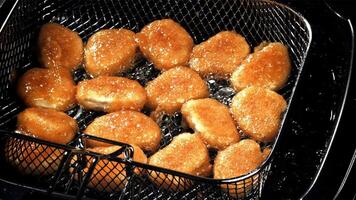 Chicken nuggets are fried in oil. Filmed on a high-speed camera at 1000 fps. High quality FullHD footage video