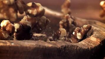 Walnuts fall into a wooden bowl. Filmed on a high-speed camera at 1000 fps. High quality FullHD footage video