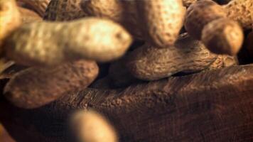 Peanuts fall into a wooden bowl. Filmed on a high-speed camera at 1000 fps. High quality FullHD footage video