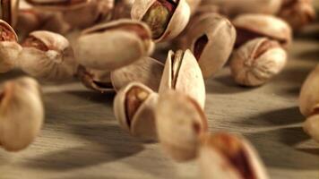 The pistachios fall on the table. Filmed on a high-speed camera at 1000 fps. High quality FullHD footage video