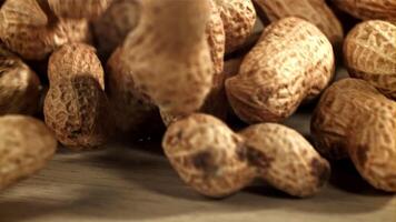 Peanuts fall on the table. Filmed on a high-speed camera at 1000 fps. High quality FullHD footage video