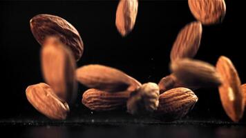 Almonds fall on the table. Filmed on a high-speed camera at 1000 fps. High quality FullHD footage video