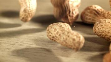 Peanuts fall on the table. Filmed on a high-speed camera at 1000 fps. High quality FullHD footage video