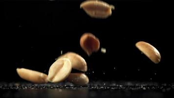 Peanuts fall on the table. Filmed on a high-speed camera at 1000 fps. High quality FullHD footage video