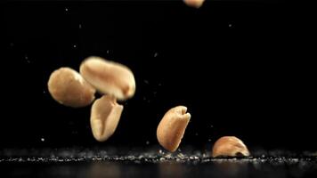 Peanuts fall on the table. Filmed on a high-speed camera at 1000 fps. High quality FullHD footage video