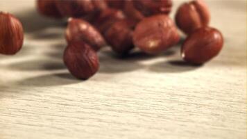 Hazelnuts fall on the table. Filmed on a high-speed camera at 1000 fps. High quality FullHD footage video