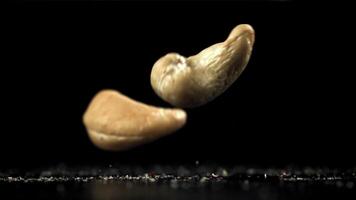 Cashew nuts fall on the table. Filmed on a high-speed camera at 1000 fps. High quality FullHD footage video