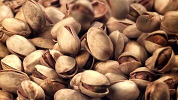 The pistachios fall on the table. Filmed on a high-speed camera at 1000 fps. High quality FullHD footage video