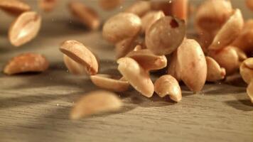 Peanuts fall on the table. Filmed on a high-speed camera at 1000 fps. High quality FullHD footage video