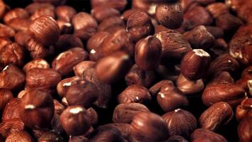 Hazelnuts fall on the table. Filmed on a high-speed camera at 1000 fps. High quality FullHD footage video