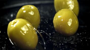 Fresco aceitunas otoño con salpicaduras dentro el aceite. filmado en un alta velocidad cámara a 1000 fps. alto calidad full HD imágenes video