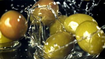 Fresh olives fall with splashes into the oil. Filmed on a high-speed camera at 1000 fps. High quality FullHD footage video