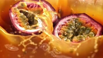 Passion fruit falls into the juice with splashes. Filmed on a high-speed camera at 1000 fps. High quality FullHD footage video