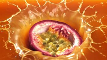 Passion fruit falls into the juice with splashes. Filmed on a high-speed camera at 1000 fps. High quality FullHD footage video