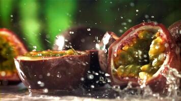 Raindrops fall on tropical passion fruit. Filmed on a high-speed camera at 1000 fps. High quality FullHD footage video