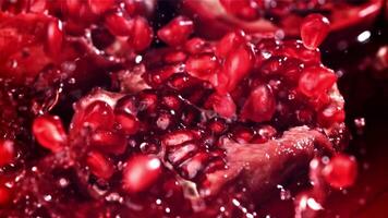 Pomegranate seeds fall into the juice. Filmed on a high-speed camera at 1000 fps. High quality FullHD footage video