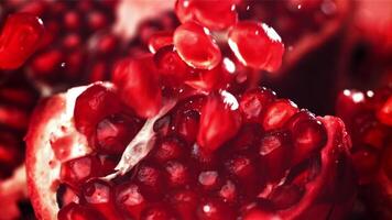 Pomegranate seeds fall on a piece. Filmed on a high-speed camera at 1000 fps. High quality FullHD footage video