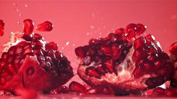 Chunks of fresh pomegranate fall on the table. Filmed on a high-speed camera at 1000 fps. High quality FullHD footage video