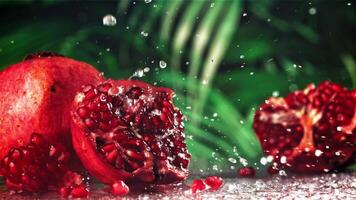 Raindrops fall on a fresh pomegranate. Filmed on a high-speed camera at 1000 fps. High quality FullHD footage video
