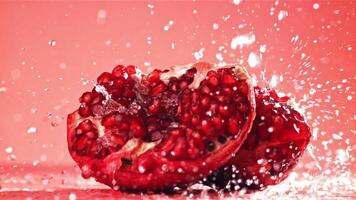 Raindrops fall on a fresh pomegranate. Filmed on a high-speed camera at 1000 fps. High quality FullHD footage video