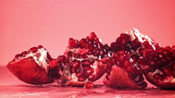 Chunks of fresh pomegranate fall on the table. Filmed on a high-speed camera at 1000 fps. High quality FullHD footage video