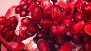 Pomegranate seeds fall on a piece. Filmed on a high-speed camera at 1000 fps. High quality FullHD footage video