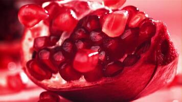 Pomegranate seeds fall on a piece. Filmed on a high-speed camera at 1000 fps. High quality FullHD footage video