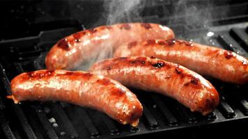 Sausages are fried with splashes in a pan. Filmed on a high-speed camera at 1000 fps. High quality FullHD footage video