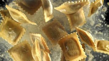 Italian ravioli fly up and fall down with flour. Filmed on a high-speed camera at 1000 fps. High quality FullHD footage video