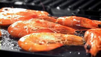 The shrimp is fried in a pan with a splash. Filmed on a high-speed camera at 1000 fps. High quality FullHD footage video