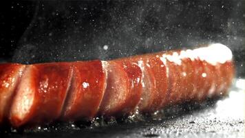 Sausages are fried with splashes in a pan. Filmed on a high-speed camera at 1000 fps. High quality FullHD footage video