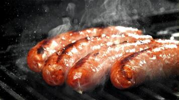 Sausages are fried with splashes in a pan. Filmed on a high-speed camera at 1000 fps. High quality FullHD footage video