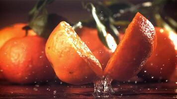 A tangerine breaks into two halves when it falls. Filmed on a high-speed camera at 1000 fps. High quality FullHD footage video