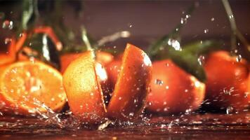 A tangerine breaks into two halves when it falls. Filmed on a high-speed camera at 1000 fps. High quality FullHD footage video