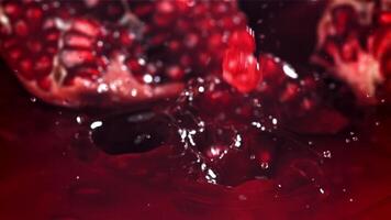 Pomegranate seeds fall into the juice. Filmed on a high-speed camera at 1000 fps. High quality FullHD footage video