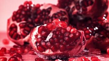 Chunks of fresh pomegranate fall on the table. Filmed on a high-speed camera at 1000 fps. High quality FullHD footage video