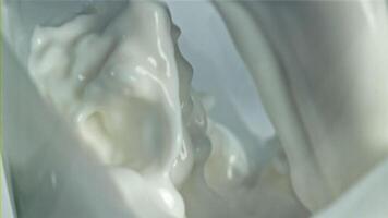 Splashes of milk in a glass. Macro shot. Filmed on a high-speed camera at 1000 fps. High quality FullHD footage video