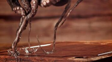 A fresh octopus falls on a cutting board. Filmed on a high-speed camera at 1000 fps. High quality FullHD footage video