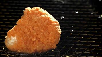 Chicken nuggets fall into hot oil. Filmed on a high-speed camera at 1000 fps. High quality FullHD footage video