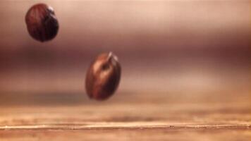 Hazelnuts fall on the table. Filmed on a high-speed camera at 1000 fps. High quality FullHD footage video