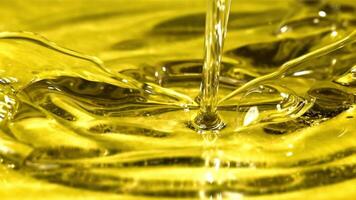 Olive oil with splashes on yellow background. Filmed on a high-speed camera at 1000 fps. High quality FullHD footage video