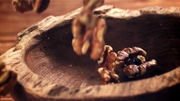 Walnuts fall into a wooden bowl. Filmed on a high-speed camera at 1000 fps. High quality FullHD footage video