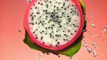 Water is poured on a cut dragon fruit. Filmed on a high-speed camera at 1000 fps. High quality FullHD footage video